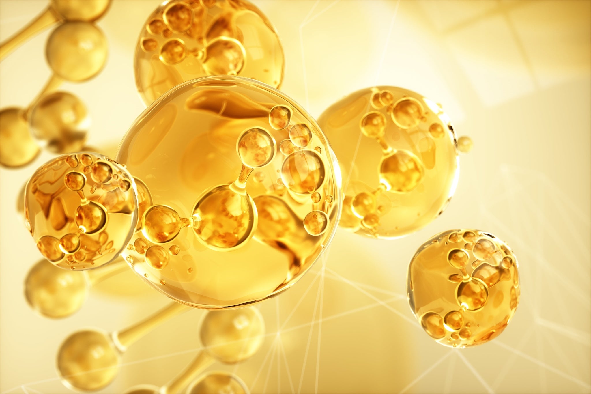 Nahaufnahme goldener Omega-3-Öl-Moleküle – hochwertige Fettsäuren für Gesundheit, Herzfunktion und Zellschutz.